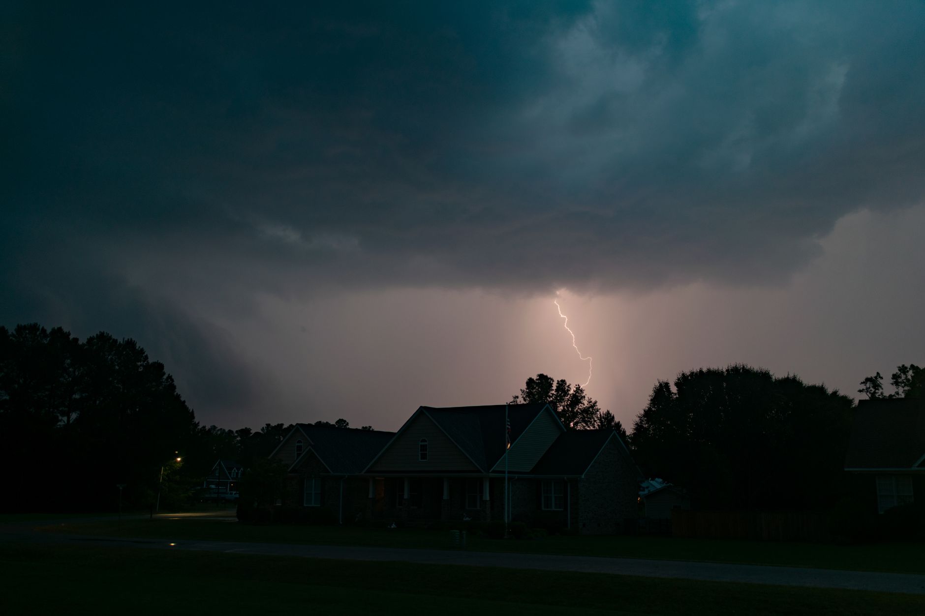 a dark suburban home with no lights during a nighttime power outage