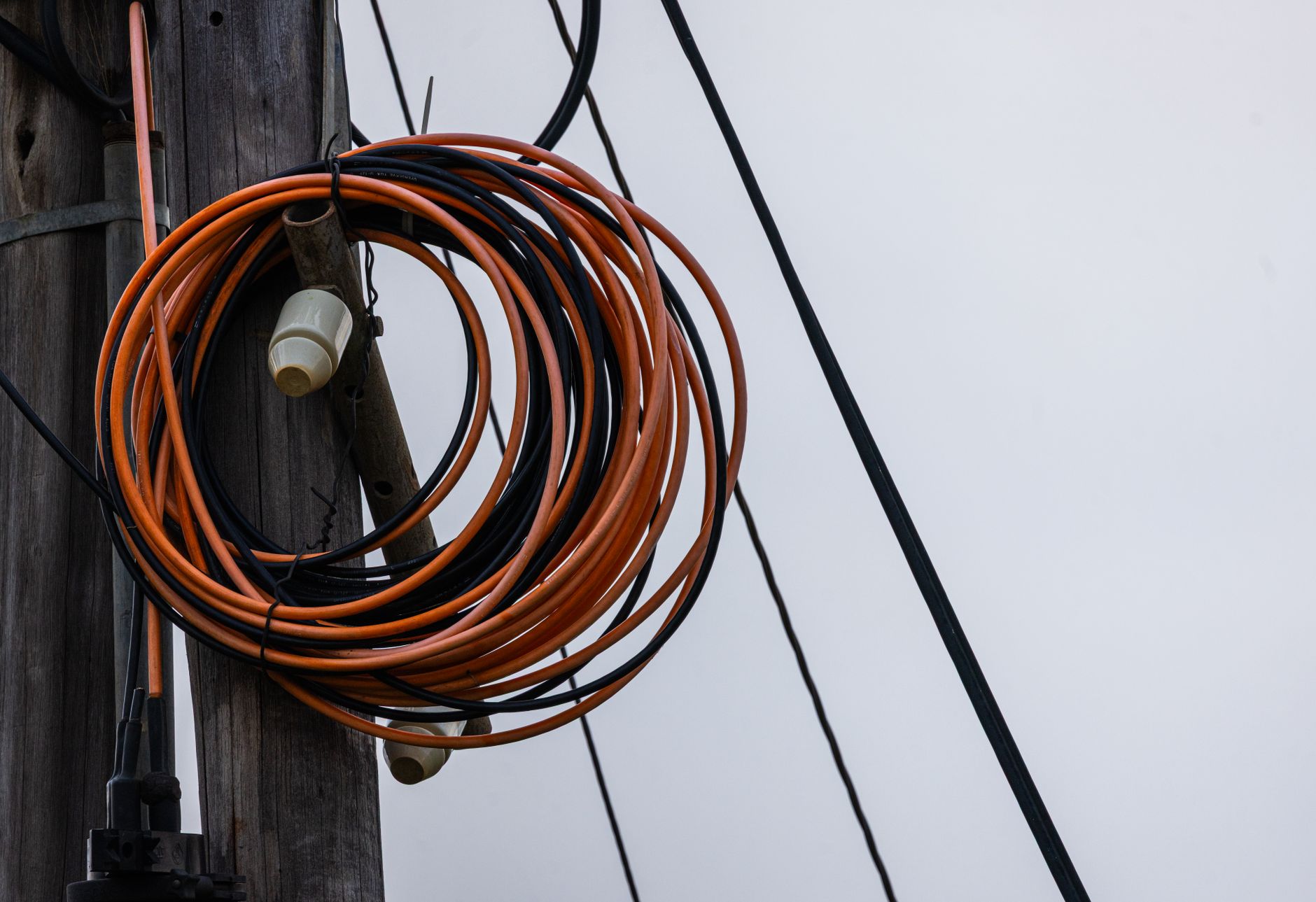a heavy-duty outdoor-rated extension cord connected to a portable generator on dry ground