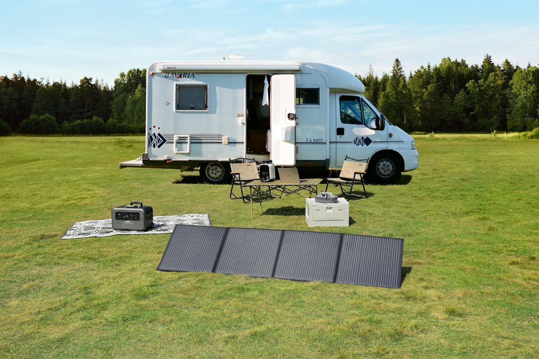 Woman plugging an extension cord from a power station into an RV shore inlet